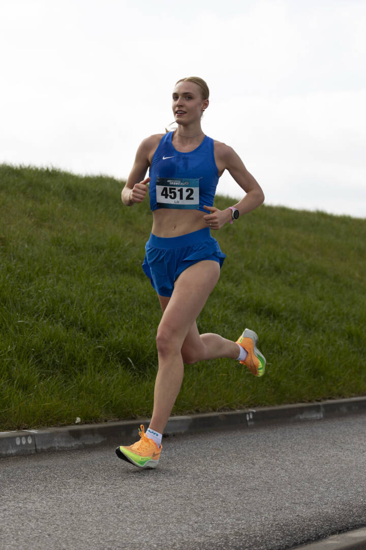 Gewinnerin Lili Schau auf Asphalt. hinter ihr der Deich. Foto: Johannes Schölermann